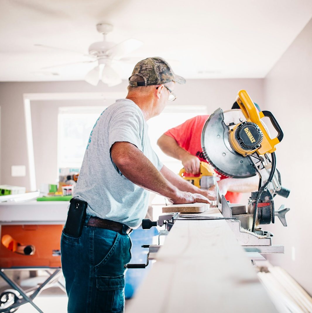 man standing infront of miter saw